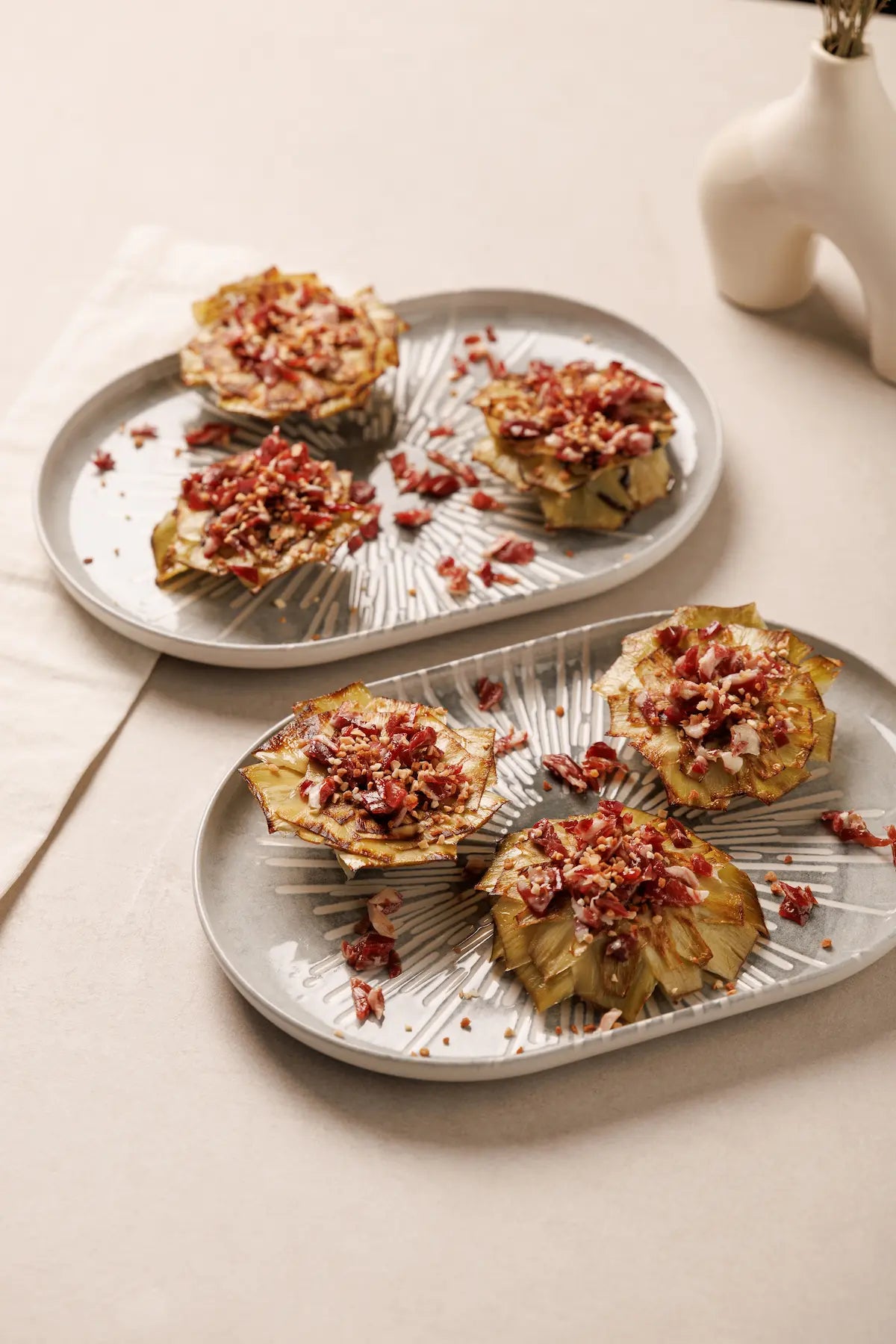 Flores de Alcachofa Confitada en AOVE con Virutas de Jamón Ibérico y Crocanti de Almendra (6 uds.)